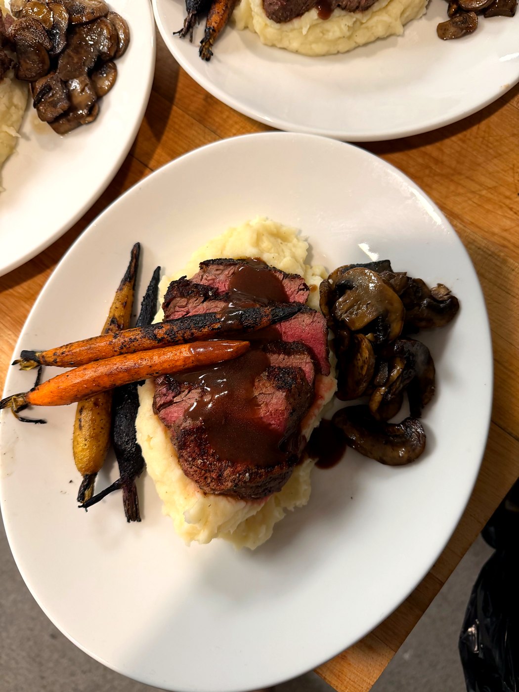 Filet with mashed potatoes, roasted carrots and mushrooms