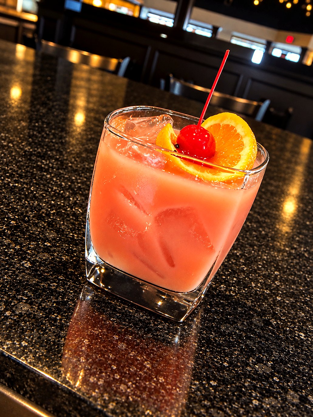 House cocktail with orange and cherry at the 1846 bar